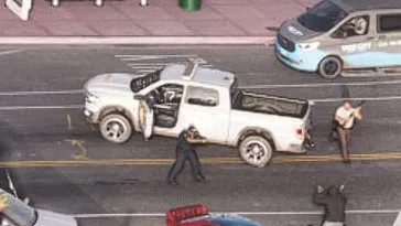 Close-up: all white crew cab pickup, no markings visible at this distance