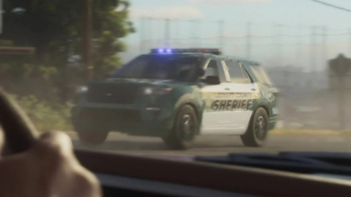 Close-up: dark green body and hood with white front and rear doors, large green SHERIFF lettering on the side with a smaller text line above it