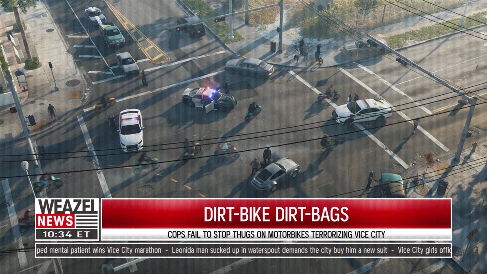 In an aerial news shot, three police cars sit in an intersection while officers stand by and dirt bike riders circle around them.