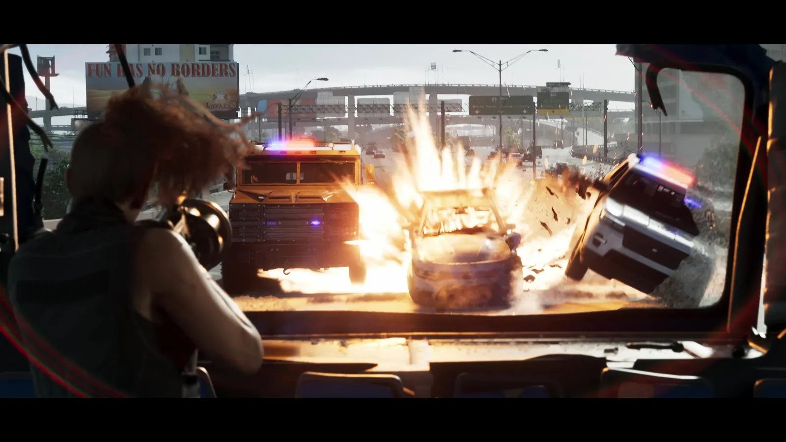 A police style SUV with its lights on is lifted onto two wheels by an explosion during a highway chase.