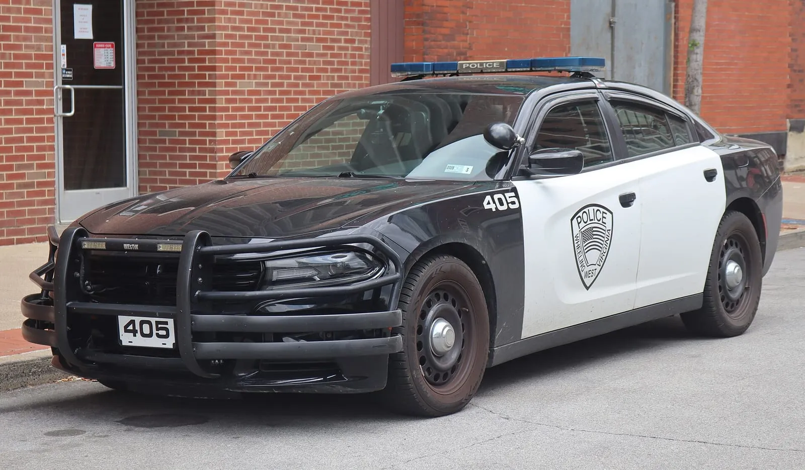 Real world photo for comparison: 2019 Dodge Charger Pursuit (Wheeling Police Department, West Virginia), front left, 06-06-2026.